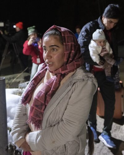 Asylum seeker Taiba Nuri is followed by her husband Mahamed Yusef Niazi, from Afghanistan, carrying their seven-month-old daughter Sahaba, cross the border at Roxham Road from New York into Canada Friday March 24, 2023 in Champlain, NY.. The federal government plans to fight allegations of discrimination for the disparate way it approached the Ukrainian and Afghan refugee crises on a single legal front, as another Canadian-Afghan sues for the right to rescue their family from the Taliban.THE CANADIAN PRESS/Ryan Remiorz